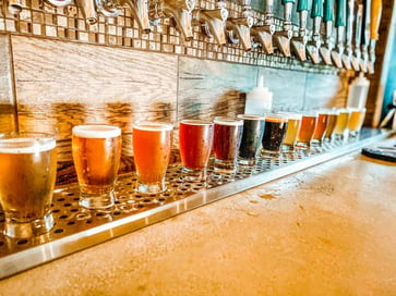 15 Beer Glasses Lined Up in a bar