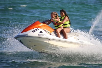 2 girls on an orange jet ski