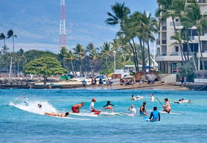 20 people in the water learning how to surf