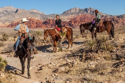 3 people riding horses through sedona