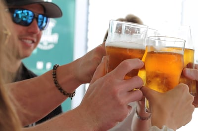 4 people cheering with beers