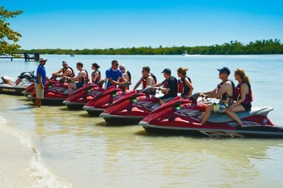 7 jetskis on the shore getting ready for a tour