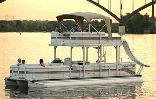 double decker pontoon boat in the ocean with a slide