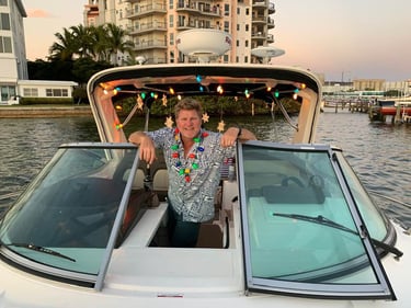 Dad on his white boat with christmas lights