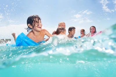 Family playing in the ocean in Florida