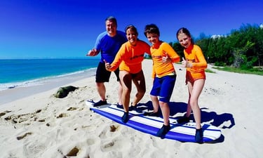 Family standing on surf board on land