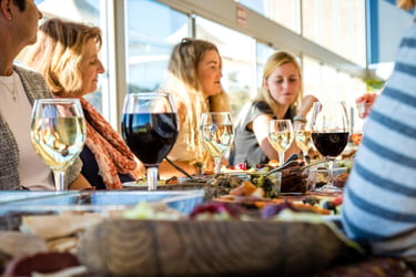 Group of people taste testing wine and food at a vineyard