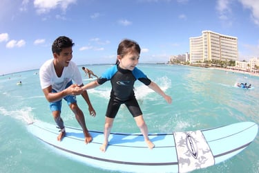 Little girl getting surf lesson on Maui