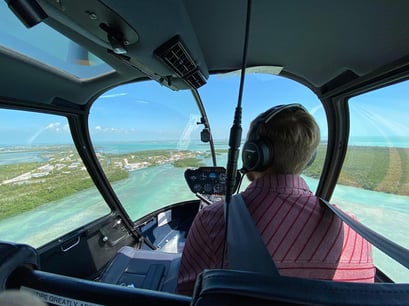 Man flying over Key West in a helicopter