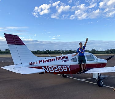 Maui Plane Rides man standing on the winf of a plane