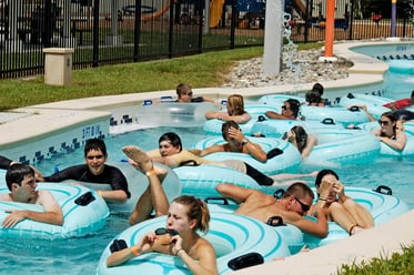 People tubing in a lazy river in a waterpark