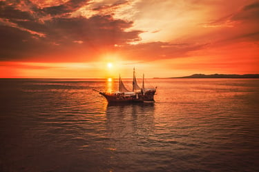 Sail boat sailing into the sunset