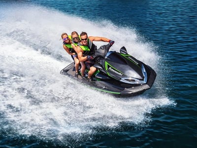 Three people riding a Jet Ski in Florida