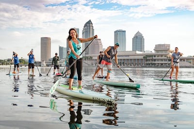 a group of people paddleboarding in tampa 