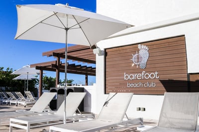 white beach chairs around a pool