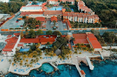 beauiful red roofed hotel in mexico on the water