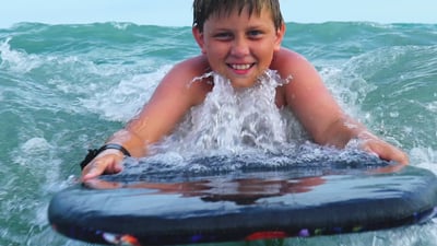 black boogie board with little boy on it