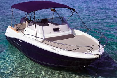 blue and white boat floating in the ocean