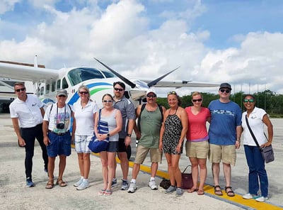 familh in front a mini air plane in mexico