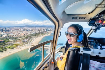 girl in a helicopter looking over the beach