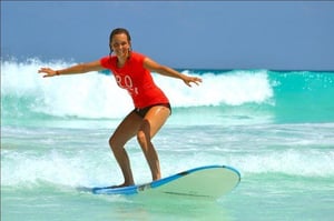 girl surf boarding in playa del carmen mexico