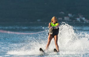 girl water skiing in lime green life jacket