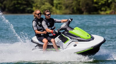 green jet ski with two people on it