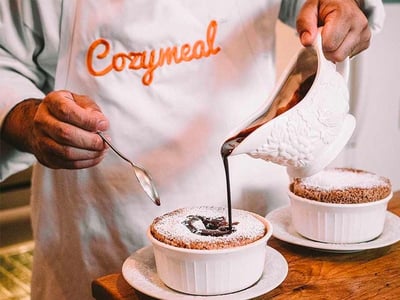 man moving chocolate over a dessert