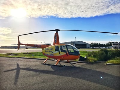 orange and yellow helicopter on the ground