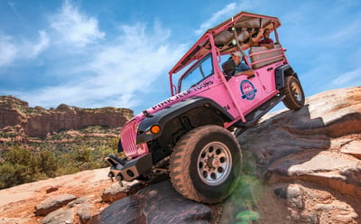 pink jeep on a rock in sedona