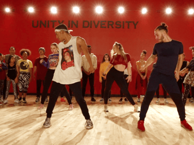 red room with people taking a dance class