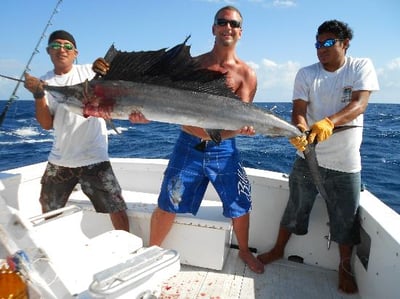 showning off a fish in playa del carmen