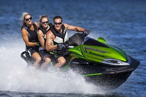 three people on a green jetski