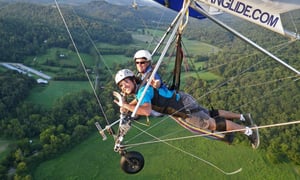 two people hang-gliding in nashville over a mountain