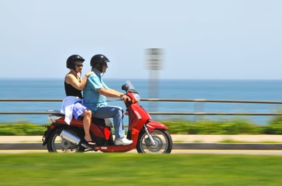 two people on a red scooter in marthas vineyard