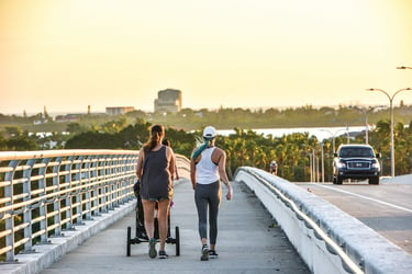 two women walking in sarasota over a bridge