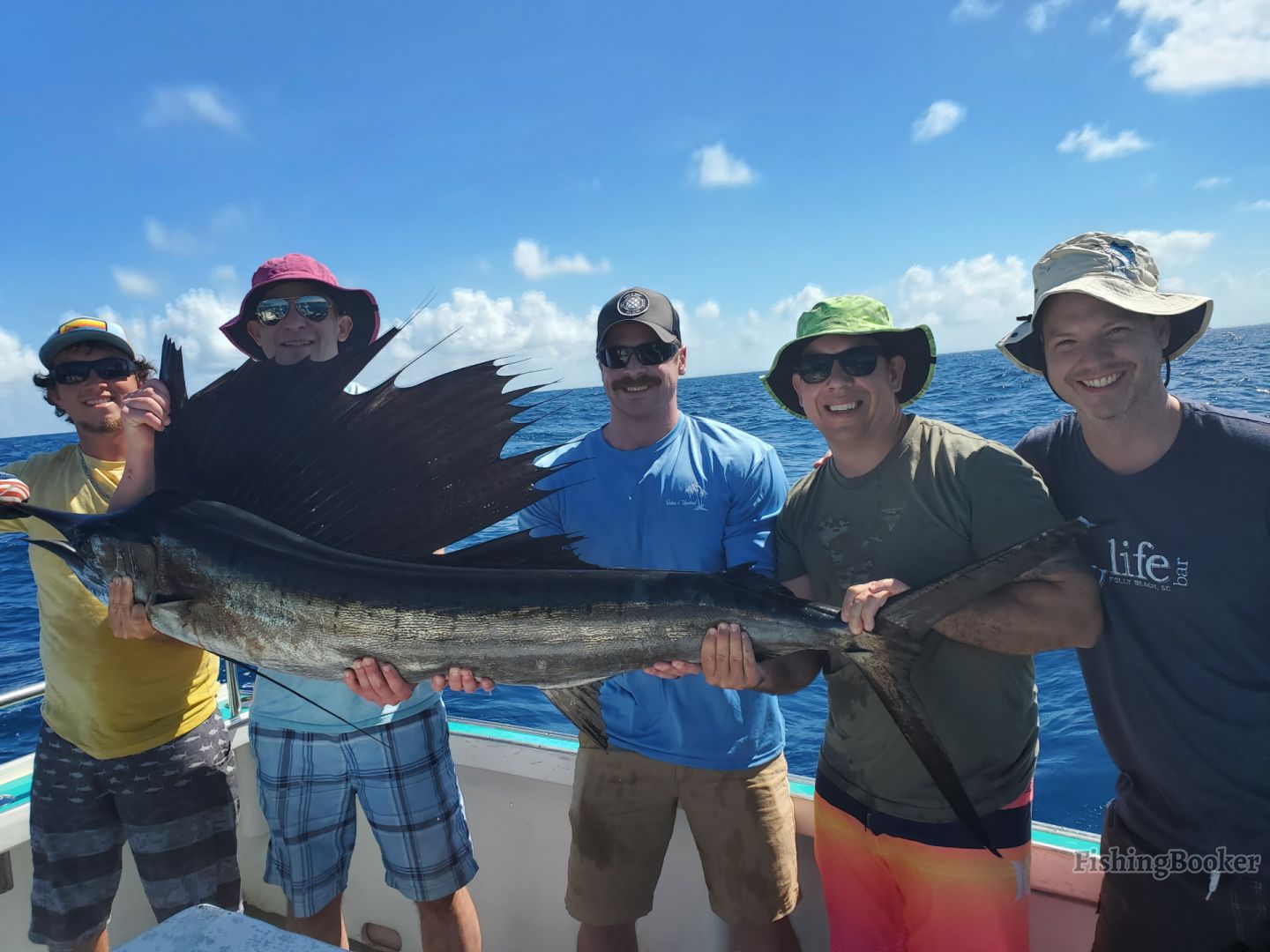 5 men holding one huge fish