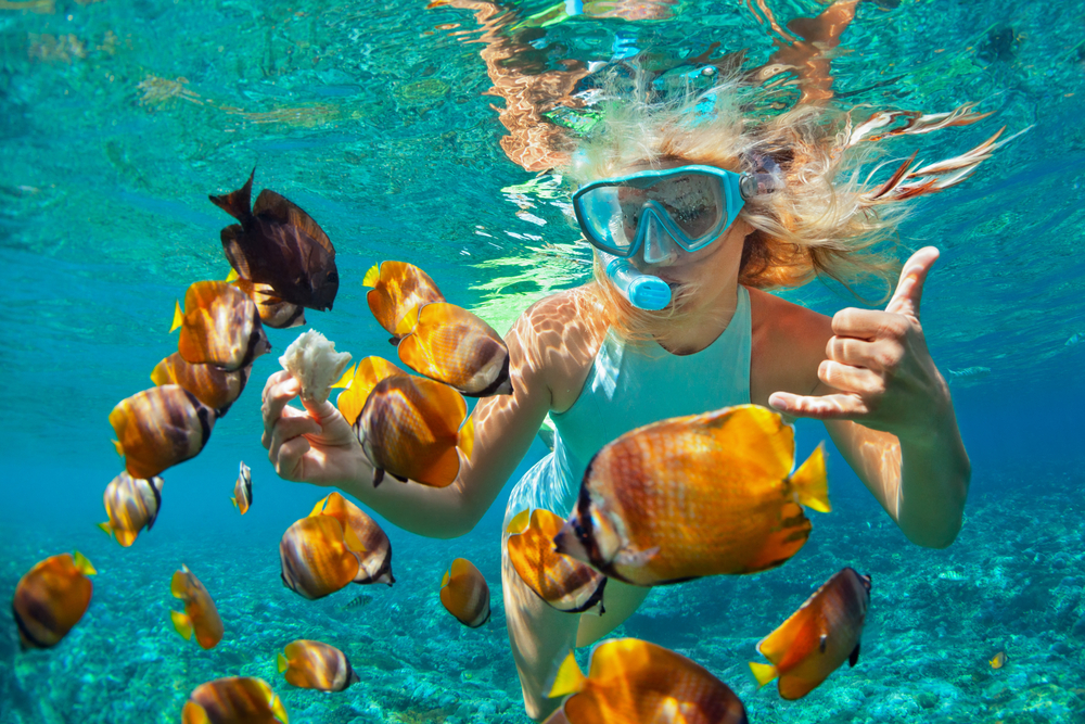 Blonde girl snorkeling in the ocean