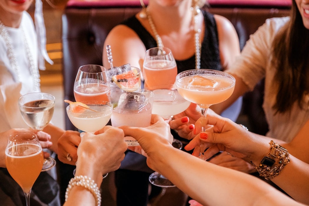 10 people cheering with cocktails 