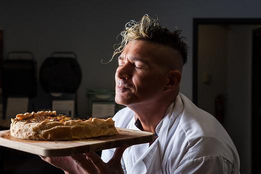 Man smelling a delicious pastry