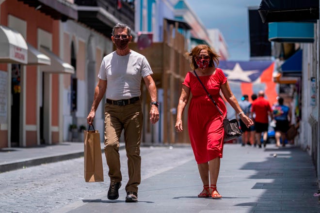 Couple walking in Old San Juan with Face Masks