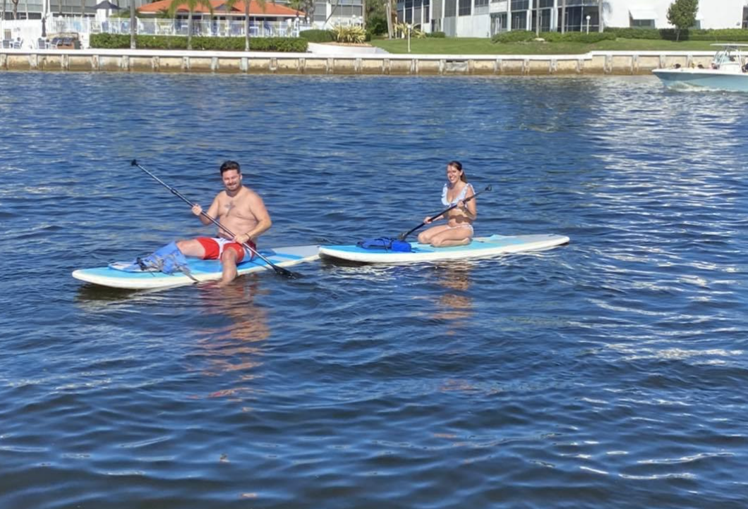 two people paddle boarding in the Boca Raton