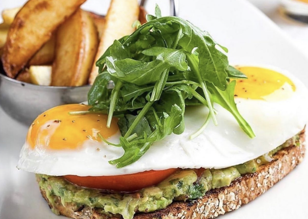 Eggs and toast with french fries and avocado 