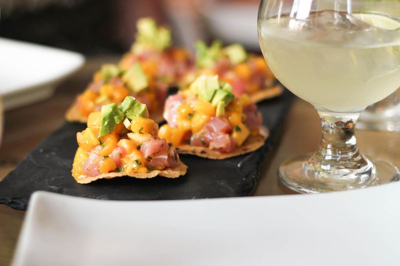 Crackers with salmon and avocado with wine