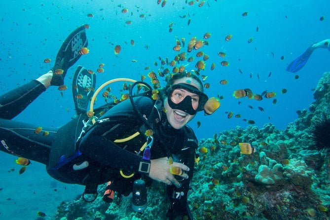 girl scuba diving with a big smile on her face