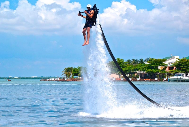 man using a jet pack in the ocean