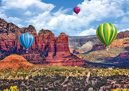 three hot air ballon among the red rocks