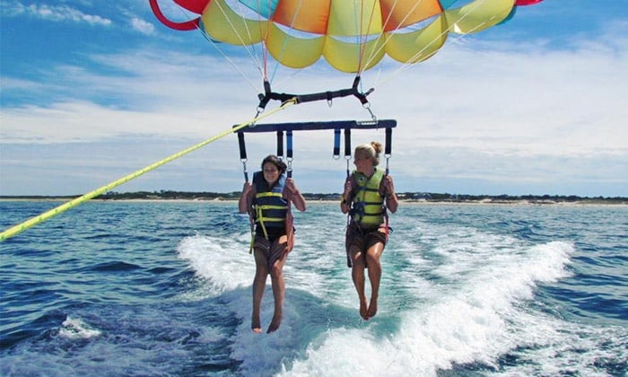 two people parasailing on dennis ma