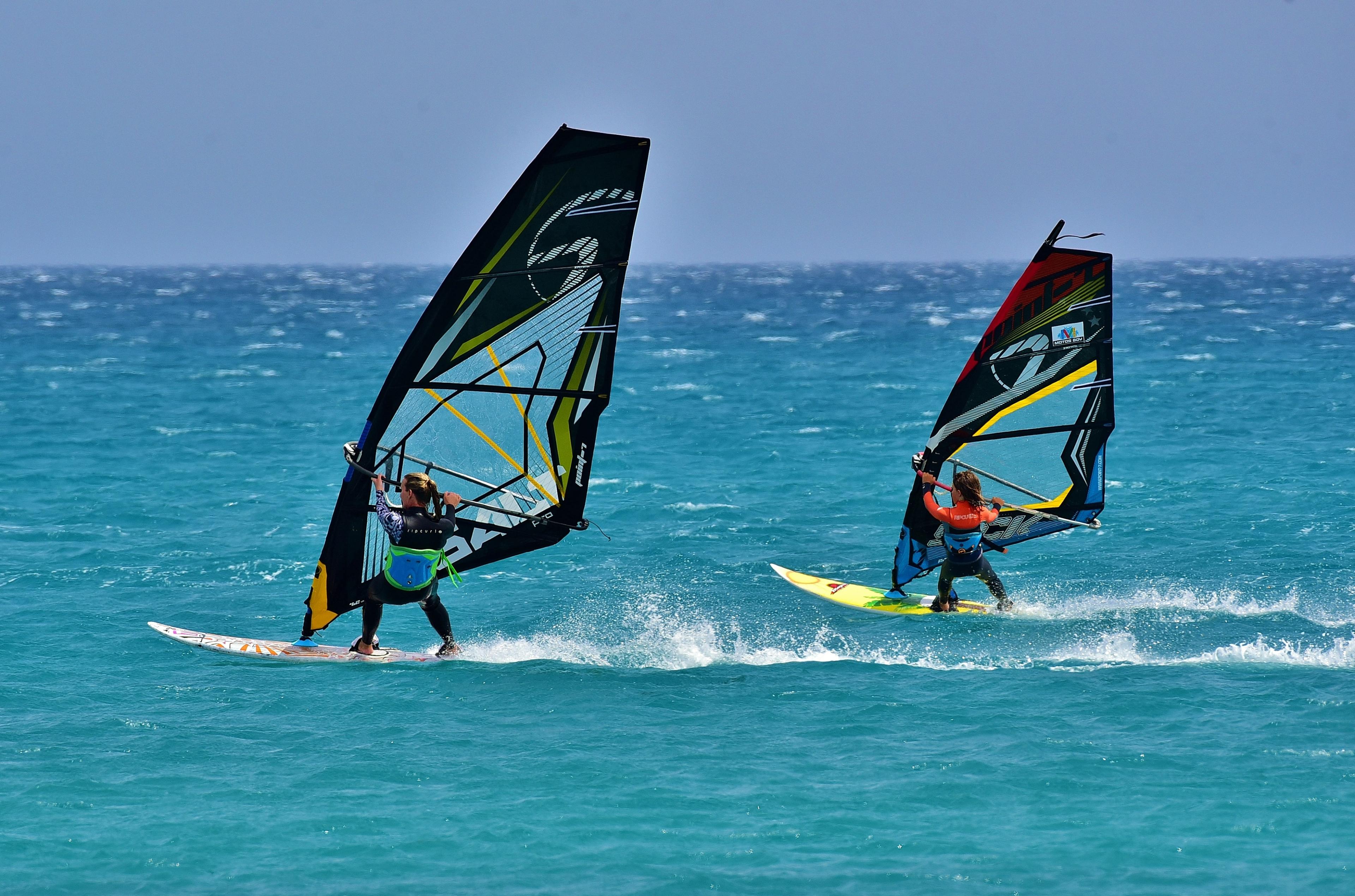 two people wind surfing